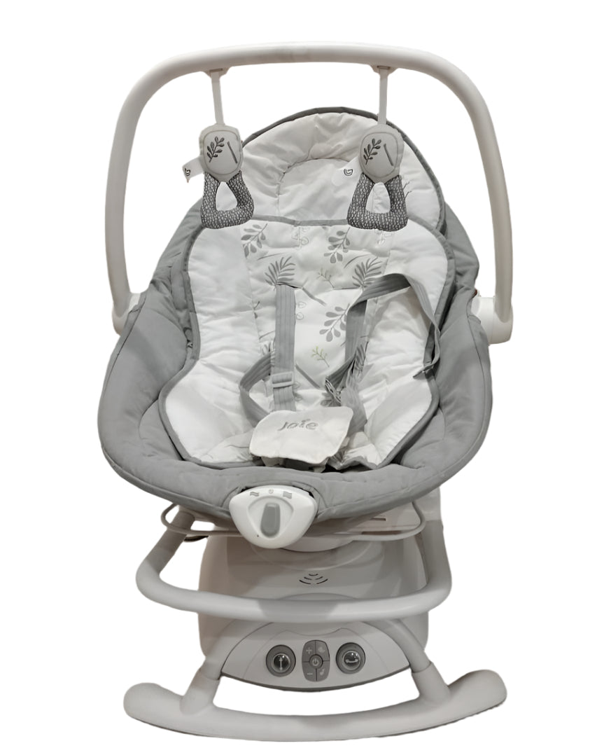 Baby swing with gray and white design on a tiled floor.