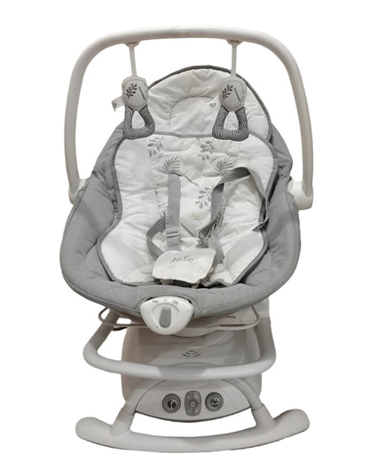 Baby swing with gray and white design on a tiled floor.