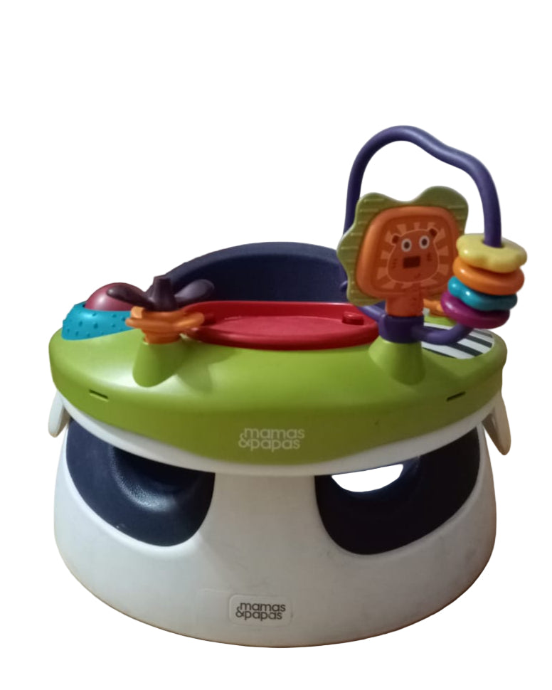 Baby activity seat with colorful toys on a wooden floor.
