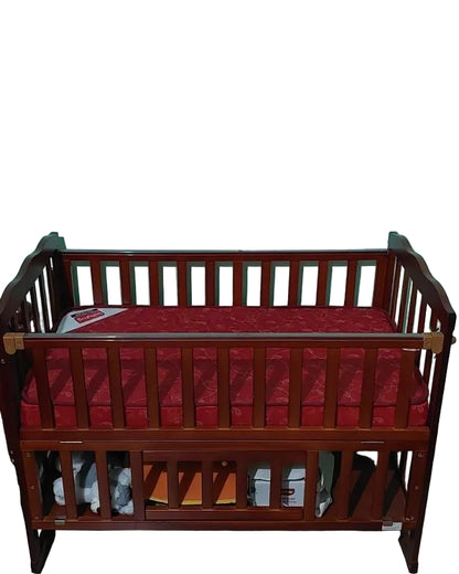 Babyhug Wooden crib with red mattress against a light green wall.